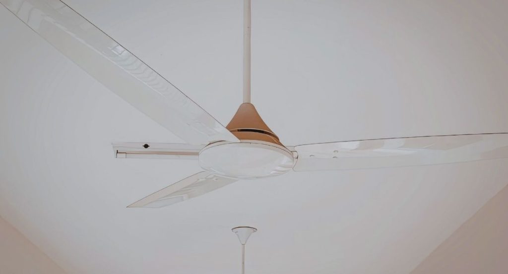 ventilateur de plafond installé dans une maison avec plafond en plâtre